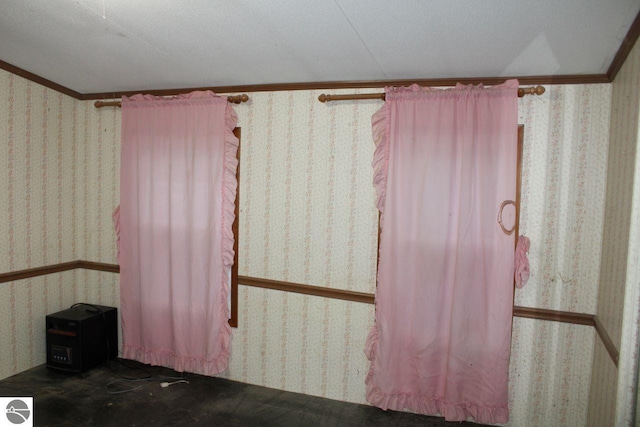 spare room with ornamental molding and a textured ceiling