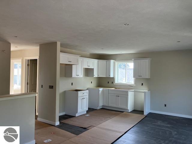 kitchen with white cabinets and hardwood / wood-style floors