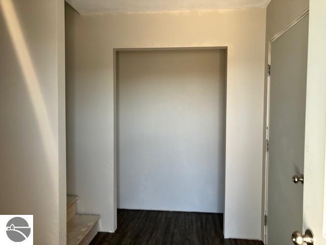 hallway with dark hardwood / wood-style floors