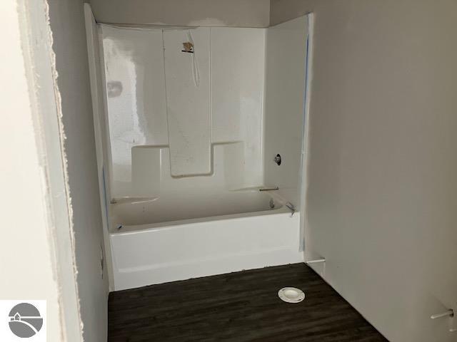 bathroom with bathing tub / shower combination