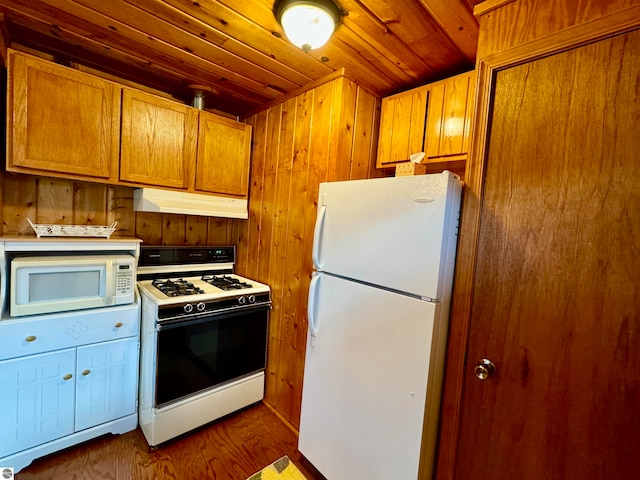 kitchen featuring wood ceiling, wooden walls, dark hardwood / wood-style floors, and white appliances