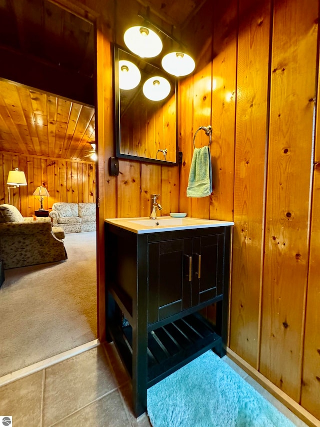 bathroom featuring vanity, wood ceiling, and wooden walls