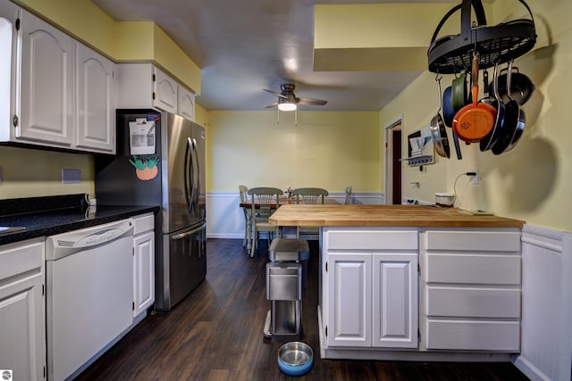 kitchen featuring stainless steel refrigerator, butcher block counters, white cabinetry, dark hardwood / wood-style flooring, and white dishwasher