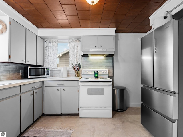 kitchen with backsplash, gray cabinets, and stainless steel appliances