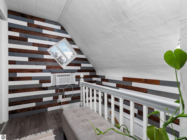 stairway with wood-type flooring and vaulted ceiling