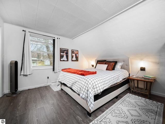 bedroom featuring dark hardwood / wood-style floors and lofted ceiling