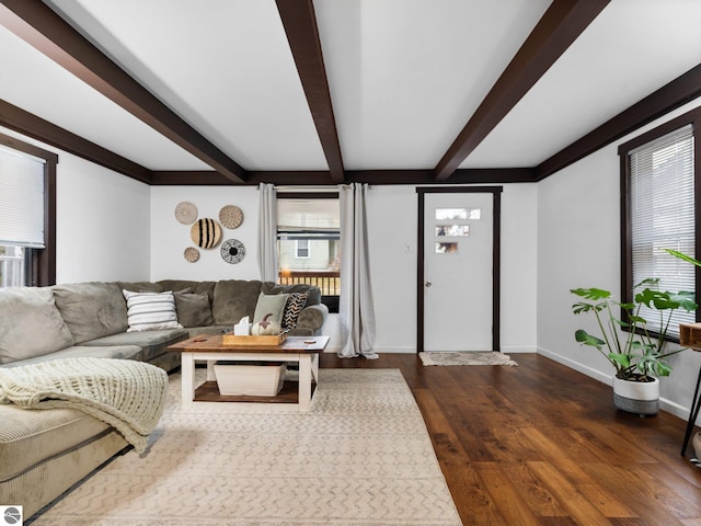 living room with beam ceiling and dark wood-type flooring