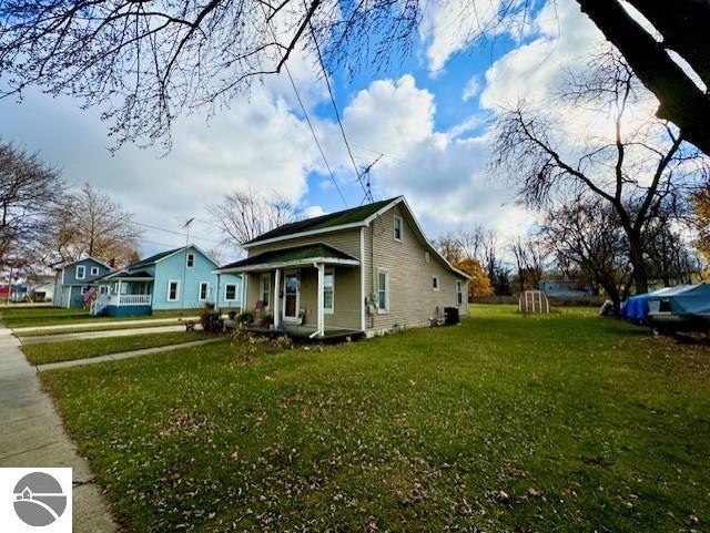 view of property exterior featuring a yard and covered porch