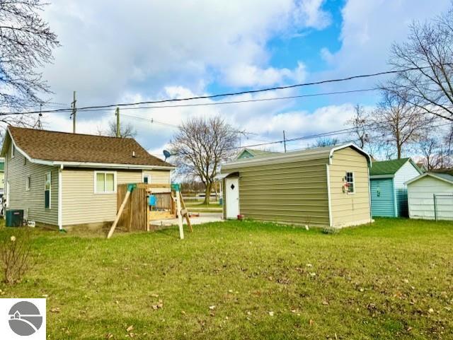 rear view of house with a yard