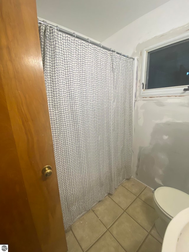 bathroom with tile patterned floors and toilet