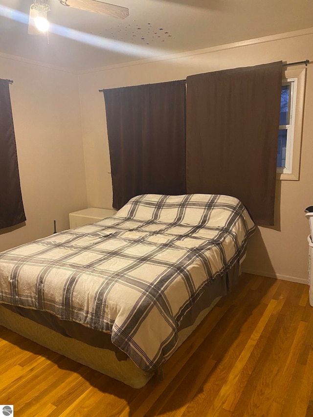 bedroom featuring ceiling fan and hardwood / wood-style flooring