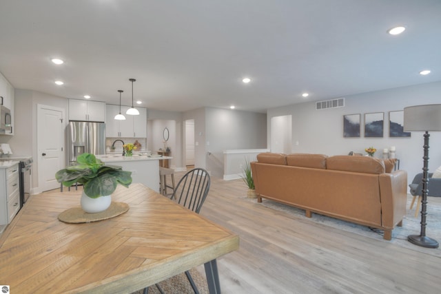 dining area with light hardwood / wood-style floors