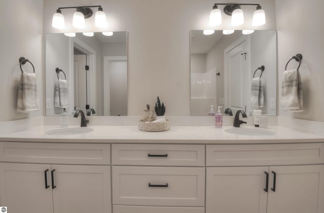 bathroom featuring a shower and vanity