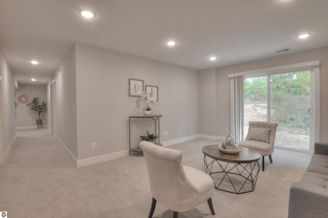 living area featuring light colored carpet