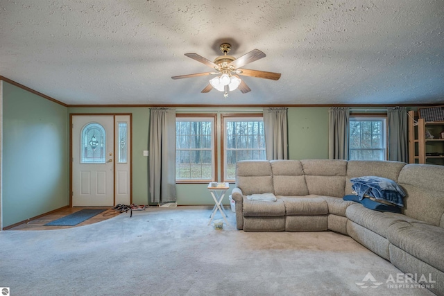 unfurnished living room with ceiling fan, plenty of natural light, and a textured ceiling