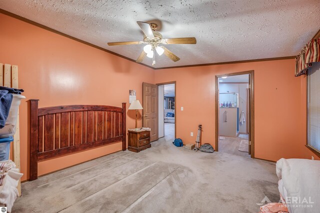 carpeted bedroom with ceiling fan, ensuite bathroom, a textured ceiling, and ornamental molding