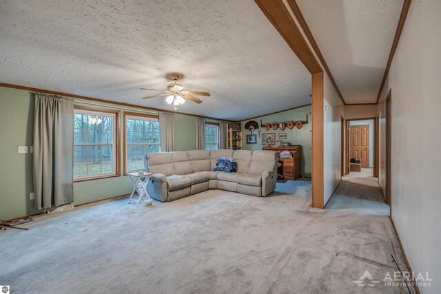 unfurnished living room featuring ceiling fan, crown molding, light carpet, and a textured ceiling