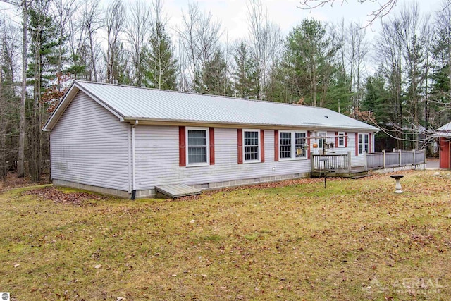 exterior space with a front yard and a deck