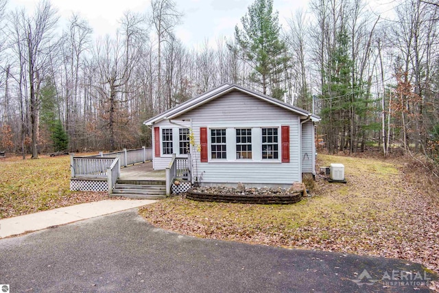 view of front of property with a deck and a front lawn