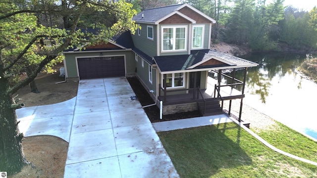 view of front of house with a front yard and a water view