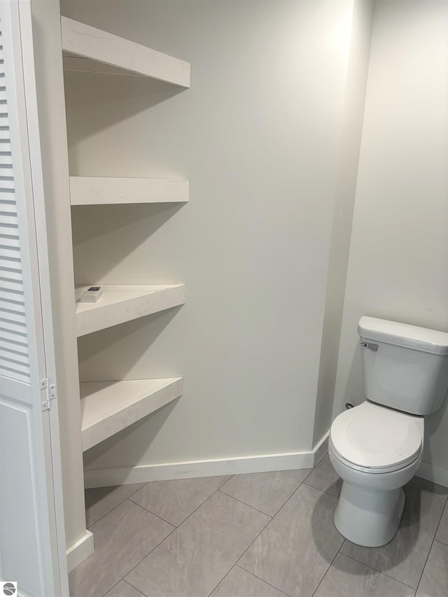 bathroom with tile patterned flooring and toilet