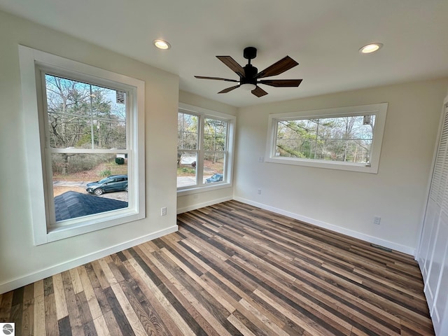 spare room with ceiling fan and dark wood-type flooring