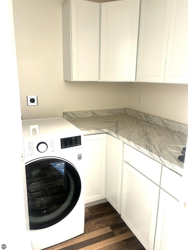 laundry room with cabinets, washer / dryer, and dark wood-type flooring