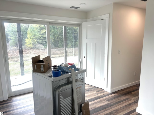 interior space with a wealth of natural light and dark wood-type flooring