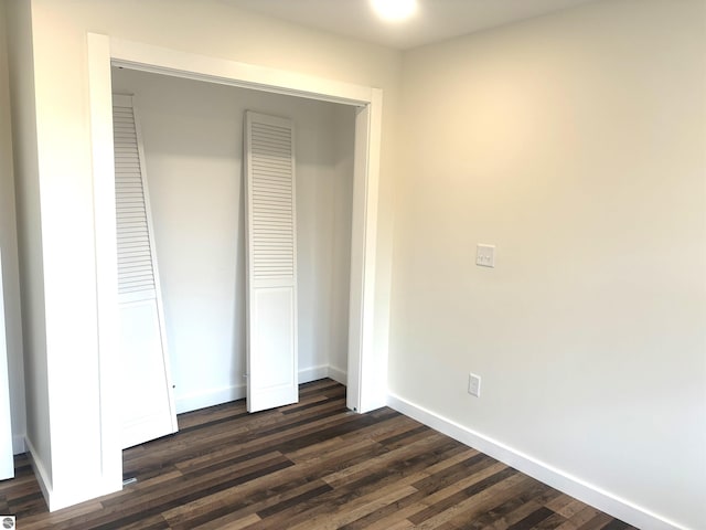 unfurnished bedroom with dark hardwood / wood-style floors