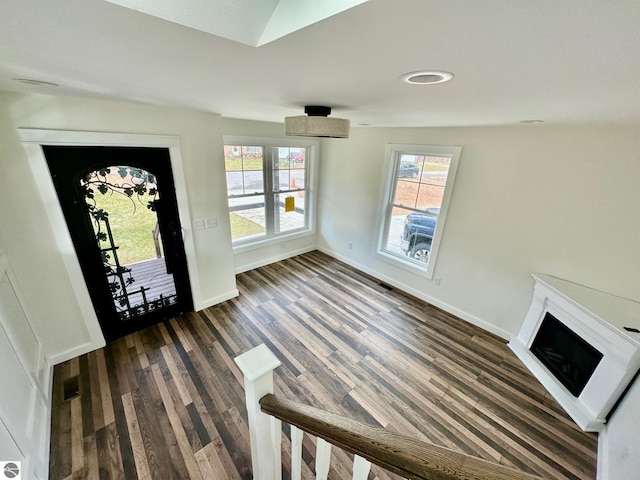 foyer featuring dark hardwood / wood-style flooring and vaulted ceiling