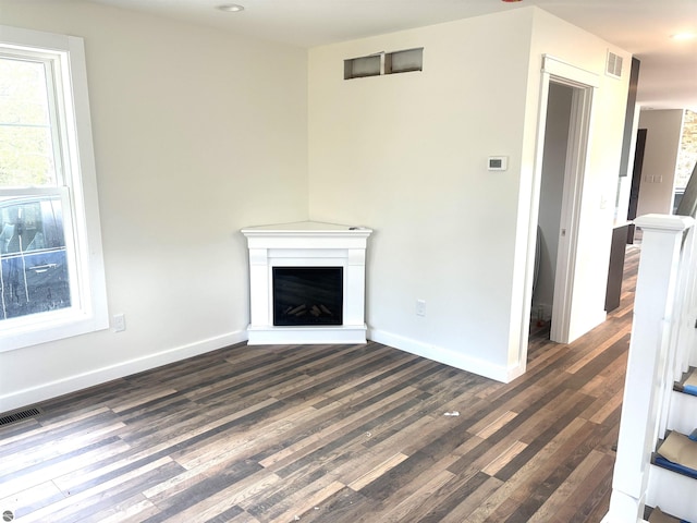 unfurnished living room with dark hardwood / wood-style floors