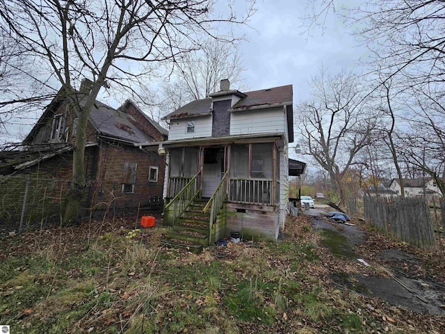 view of front of home featuring a sunroom