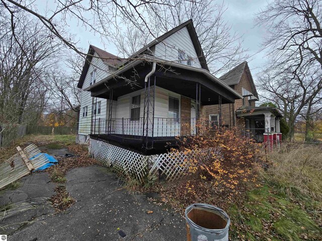 view of side of home with covered porch