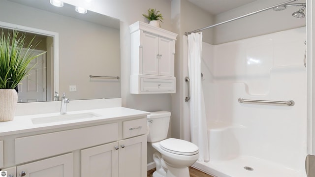 bathroom featuring hardwood / wood-style floors, vanity, toilet, and curtained shower