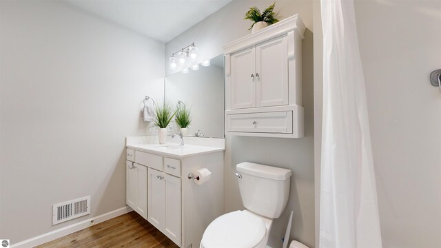 bathroom featuring hardwood / wood-style flooring, vanity, and toilet