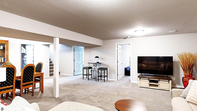 carpeted living room with a textured ceiling