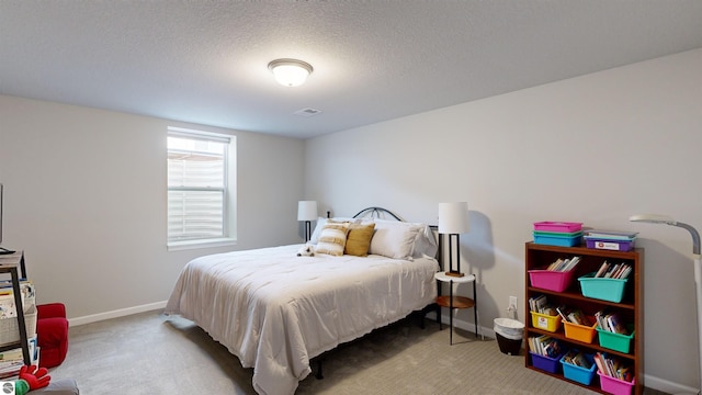 bedroom with a textured ceiling and carpet floors