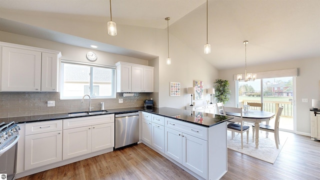 kitchen featuring pendant lighting, white cabinets, sink, and appliances with stainless steel finishes