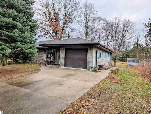 view of front of house featuring a garage and a storage shed