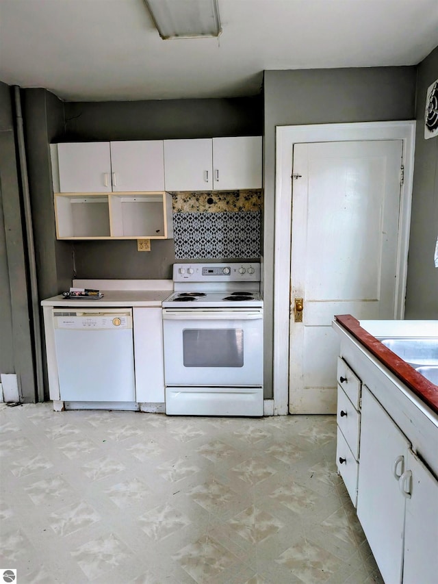 kitchen featuring decorative backsplash, white appliances, and white cabinetry