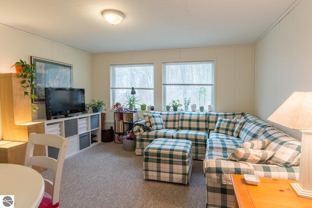 carpeted living room featuring crown molding