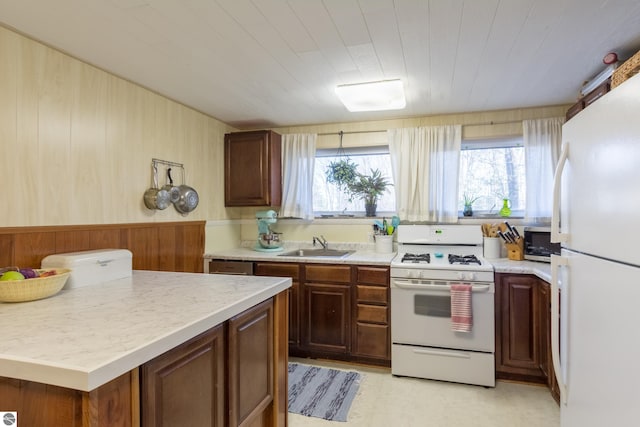 kitchen featuring white appliances and sink