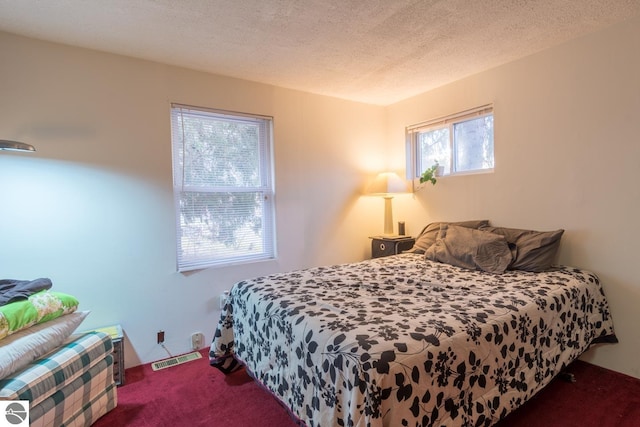 carpeted bedroom featuring a textured ceiling