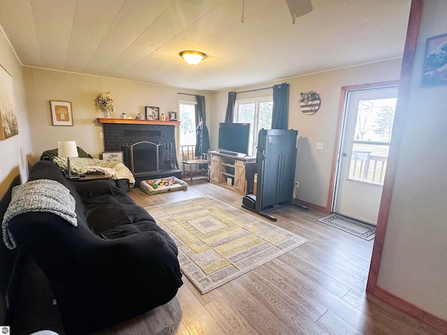 living room featuring a brick fireplace and hardwood / wood-style floors