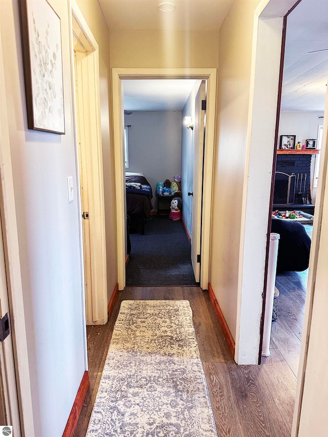 corridor with dark hardwood / wood-style flooring