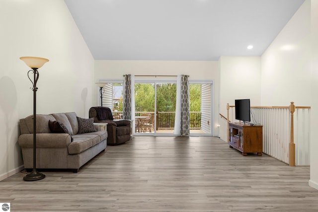 living room featuring light hardwood / wood-style flooring and lofted ceiling