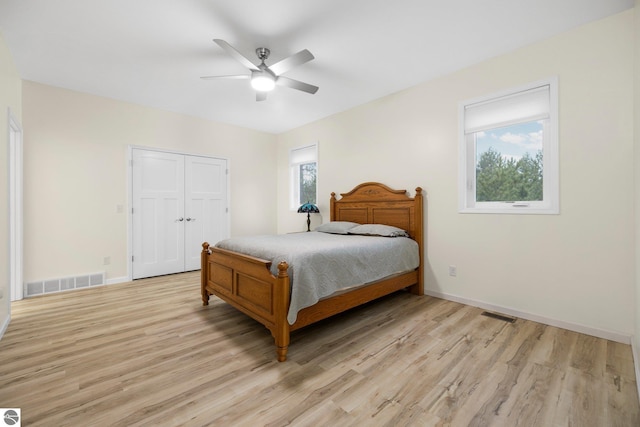 bedroom featuring ceiling fan, a closet, and light hardwood / wood-style flooring