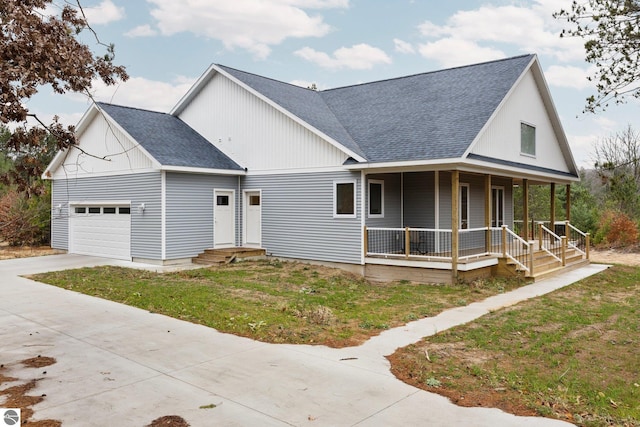 view of front of home with a garage, covered porch, and a front lawn