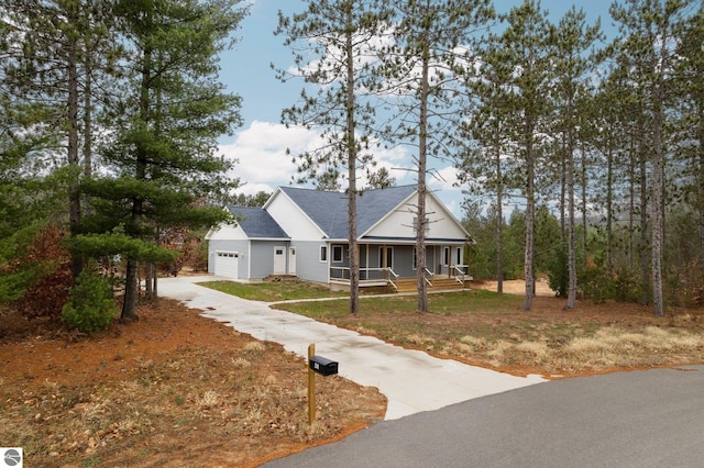 view of front facade featuring covered porch and a garage