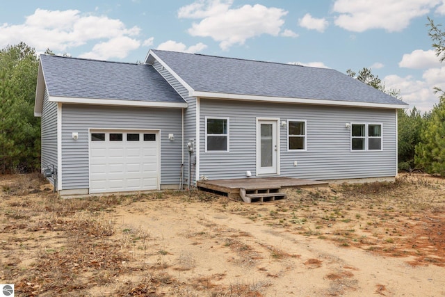 ranch-style house featuring a deck and a garage